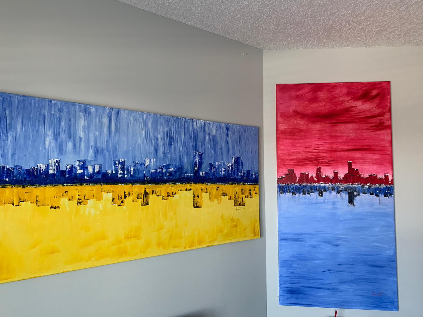 Large dual paintings for corner placement of cityscape reflected in water