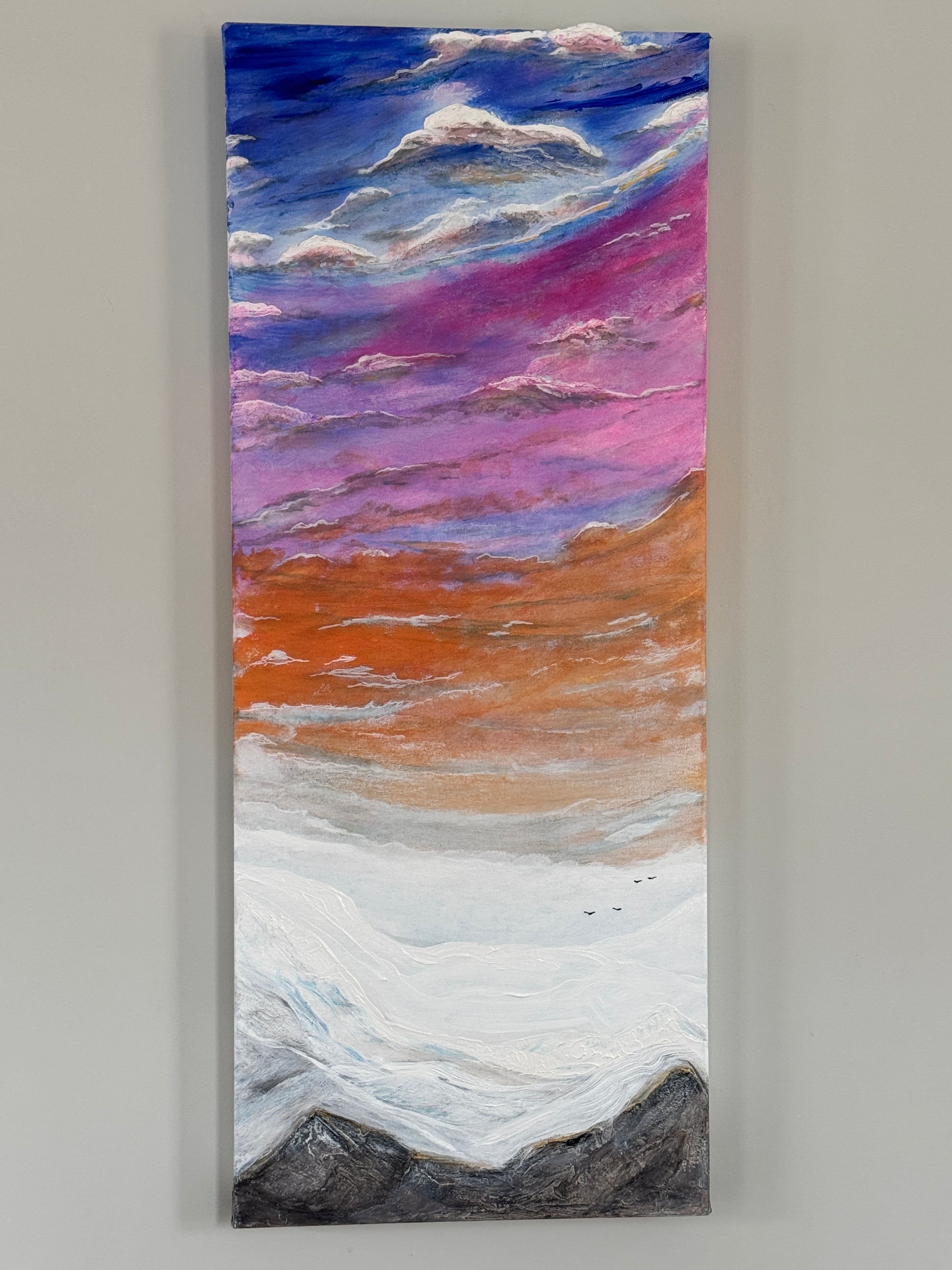 Texturized painting of a dreamy and colorful sky over mountain peaks with birds flying